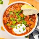 An overhead image of a bowl of pumpkin turkey chili.
