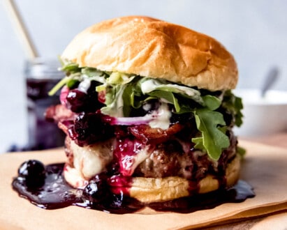 A burger with blueberry sauce.
