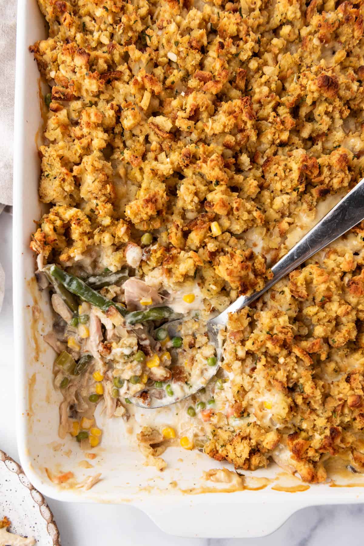 An overhead image of a pan full of chicken and stuffing casserole.