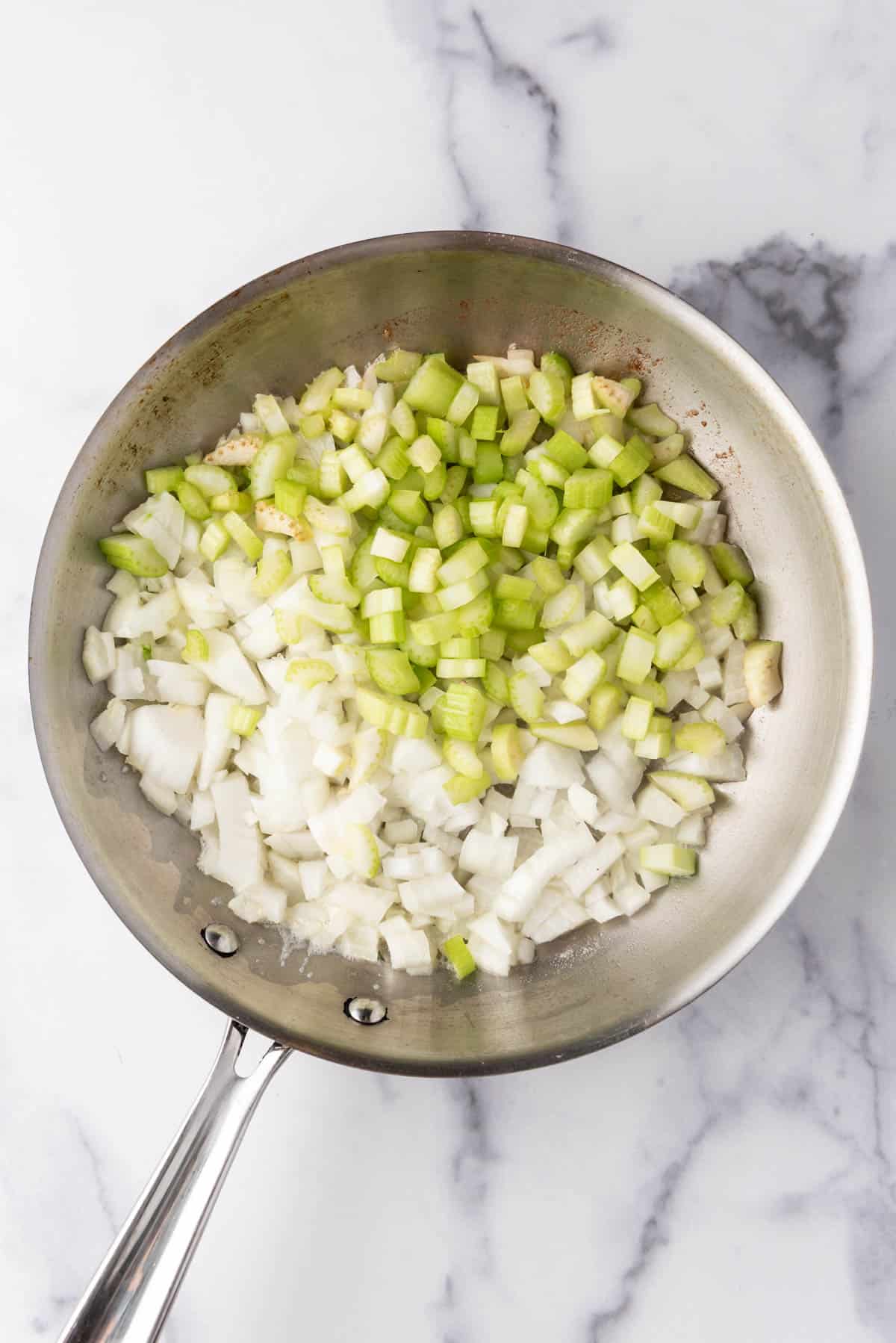 Chopped celery and onions in a large skillet.
