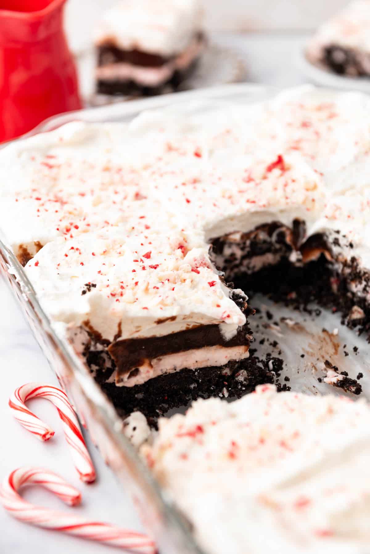 A side view of chocolate peppermint lasagna with some slices removed.