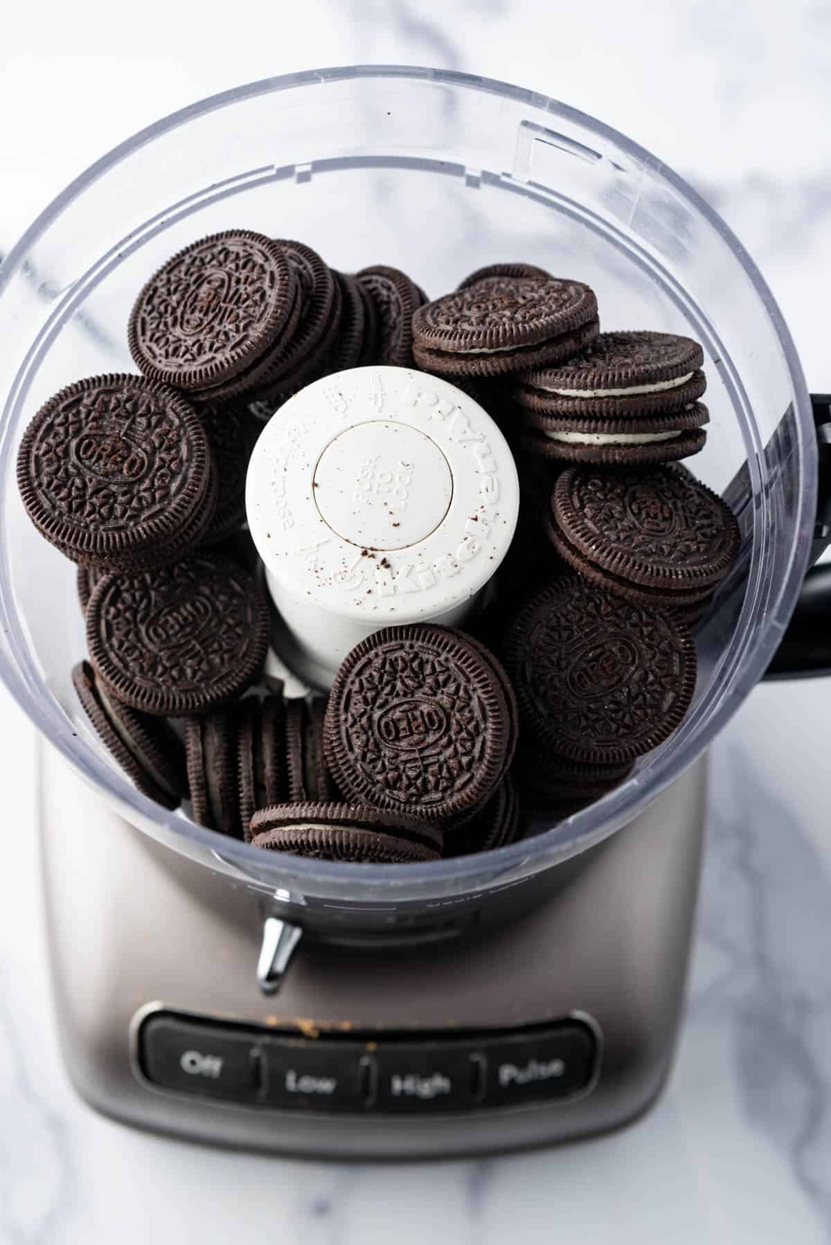 Whole Oreo cookies in a food processor.