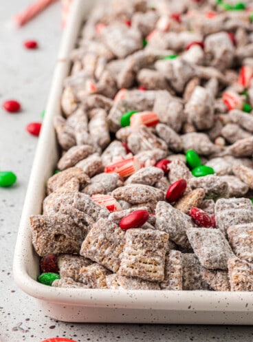 A side view of a pan of Christmas muddy buddies.