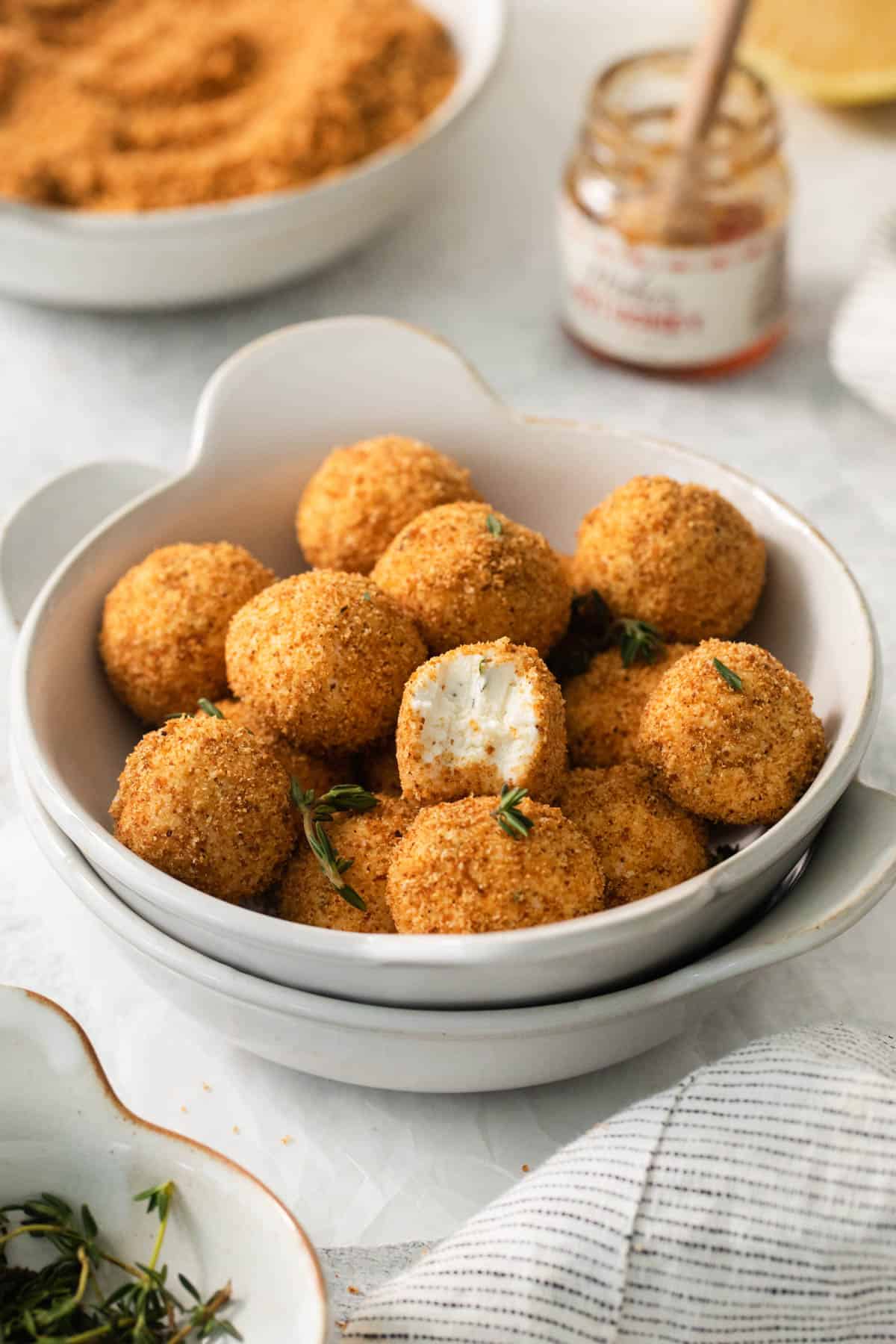 An image of crispy goat cheese bites in a bowl.