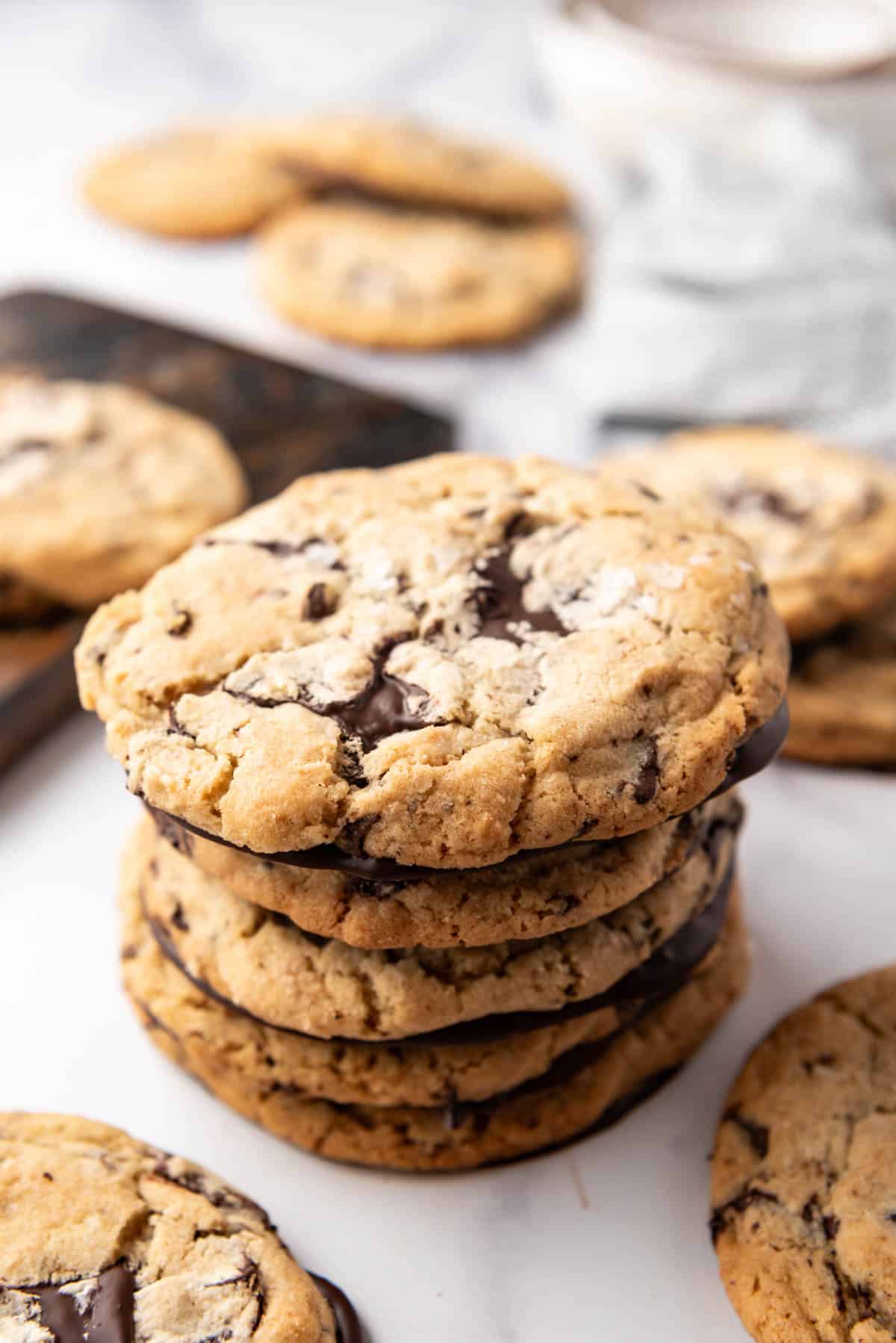 An image of a stack of Jacques Torres chocolate chip cookies with chocolate bottoms.