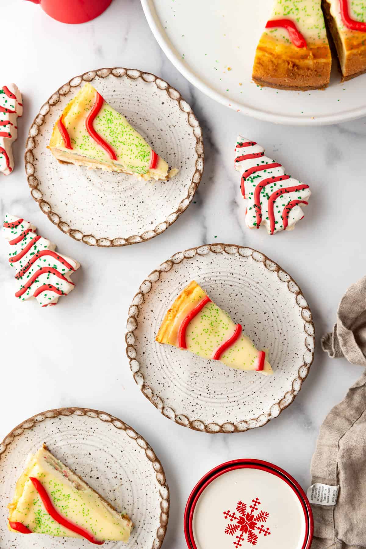 Slices of Little Debbie Christmas Tree Cheesecake on plates.