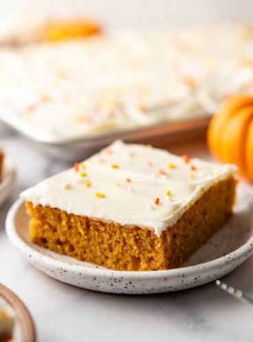 An image of a Pumpkin Bar with cream cheese frosting on a plate.