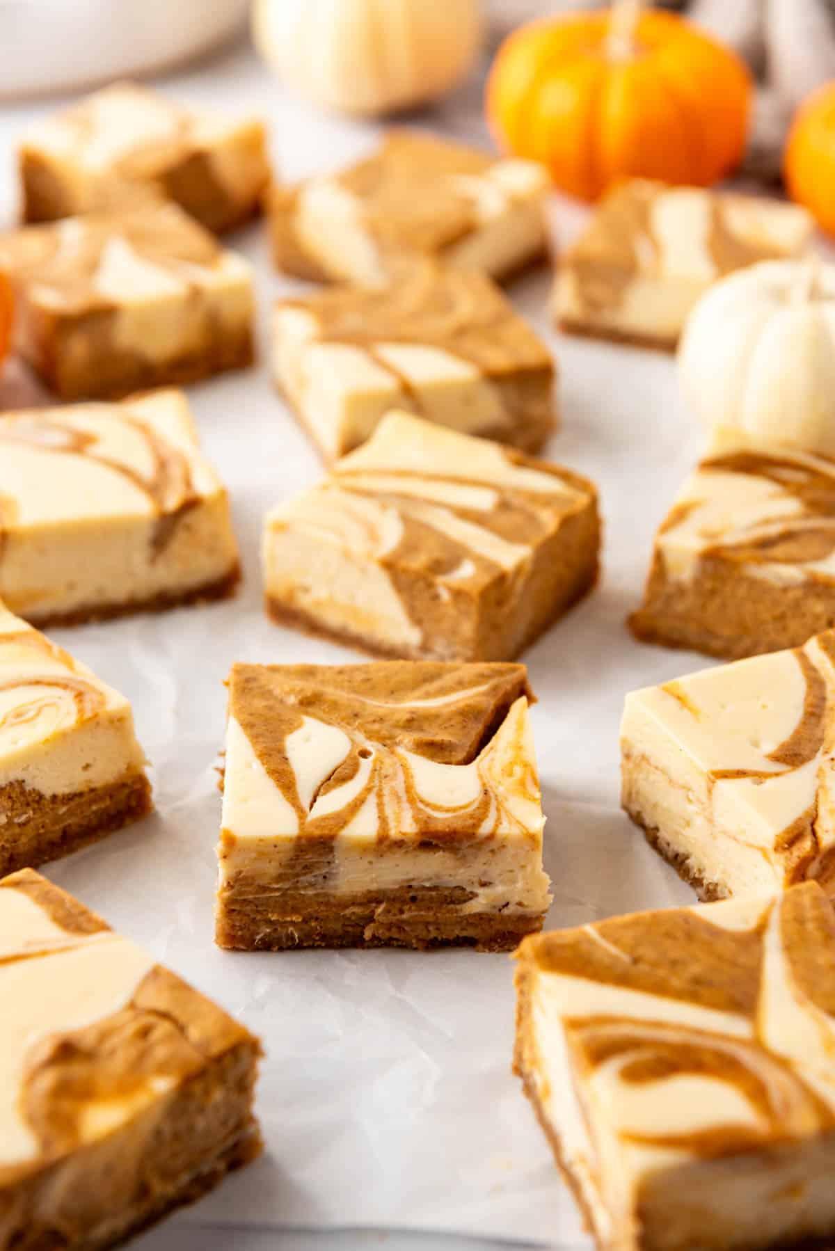 An image of pumpkin cheesecake bars cut into squares.