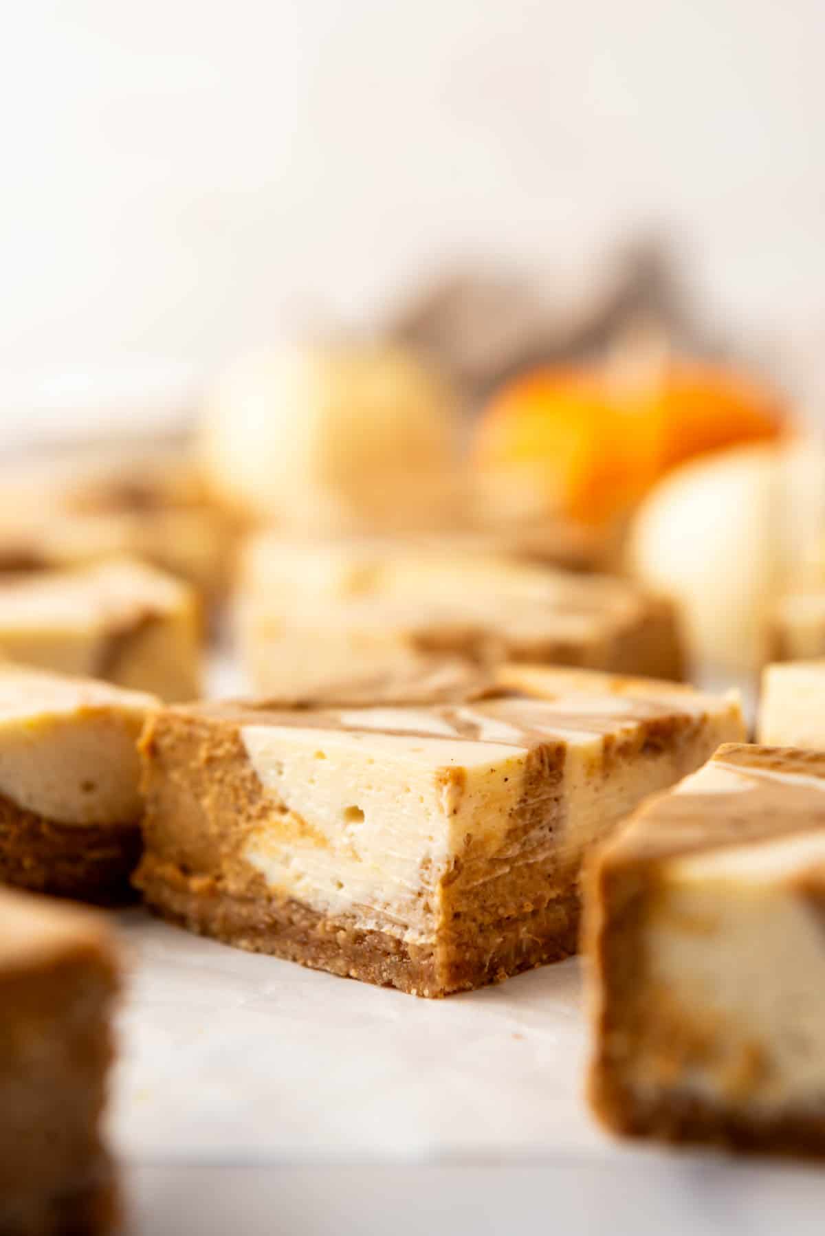 A close image of a pumpkin cheesecake bar.