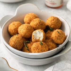 An image of crispy goat cheese bites in a bowl.