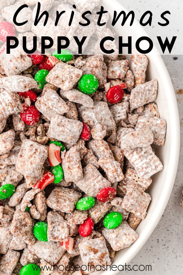 An overhead image of a bowl of Christmas muddy buddies with text overlay.