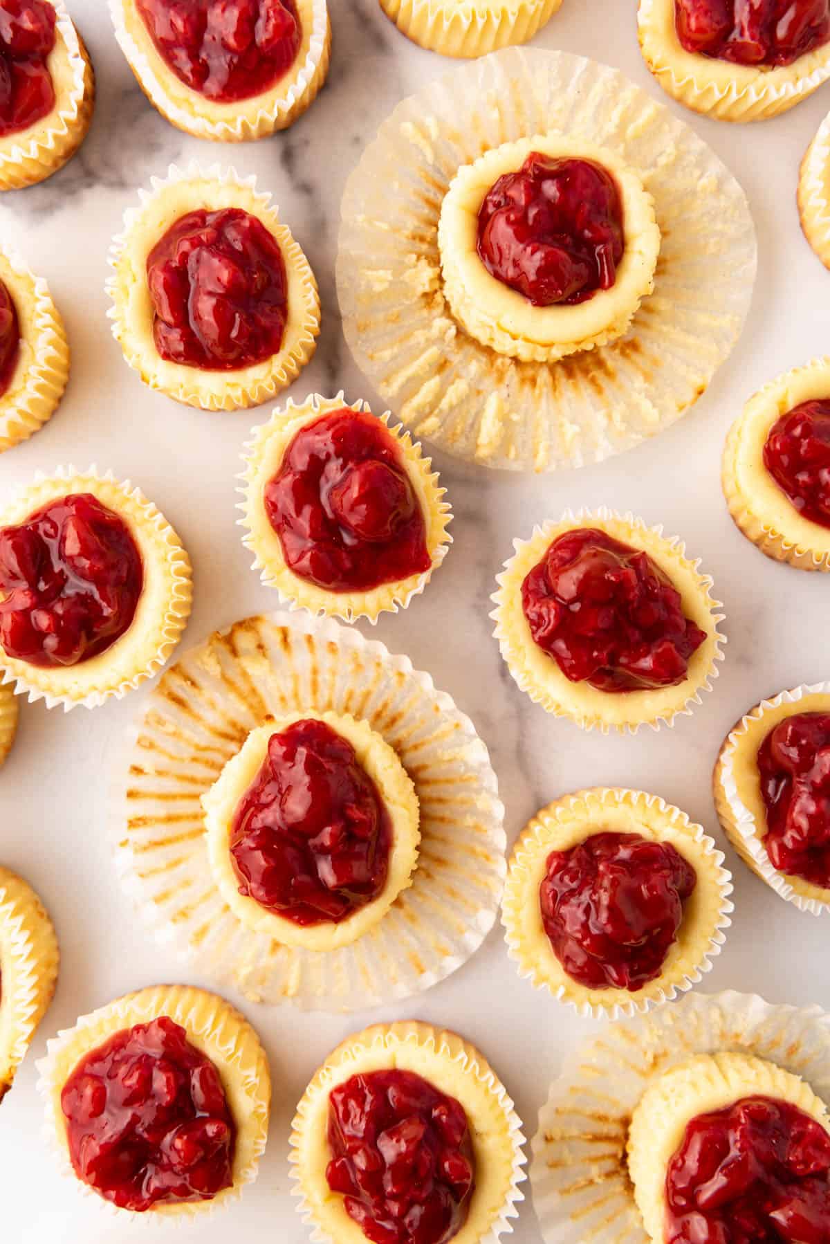 An overhead image of cherry cheesecake tarts.