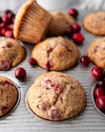 Cranberry sauce muffins in a muffin pan.