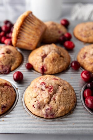 Cranberry sauce muffins in a muffin pan.