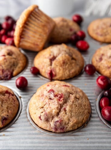 Cranberry sauce muffins in a muffin pan.