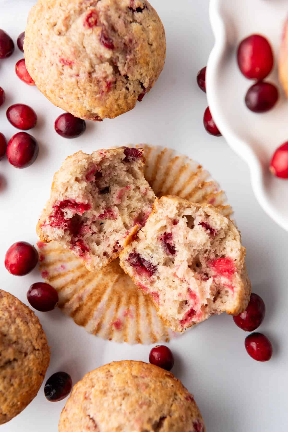 An overhead image of a cranberry sauce muffin that has been torn in half.