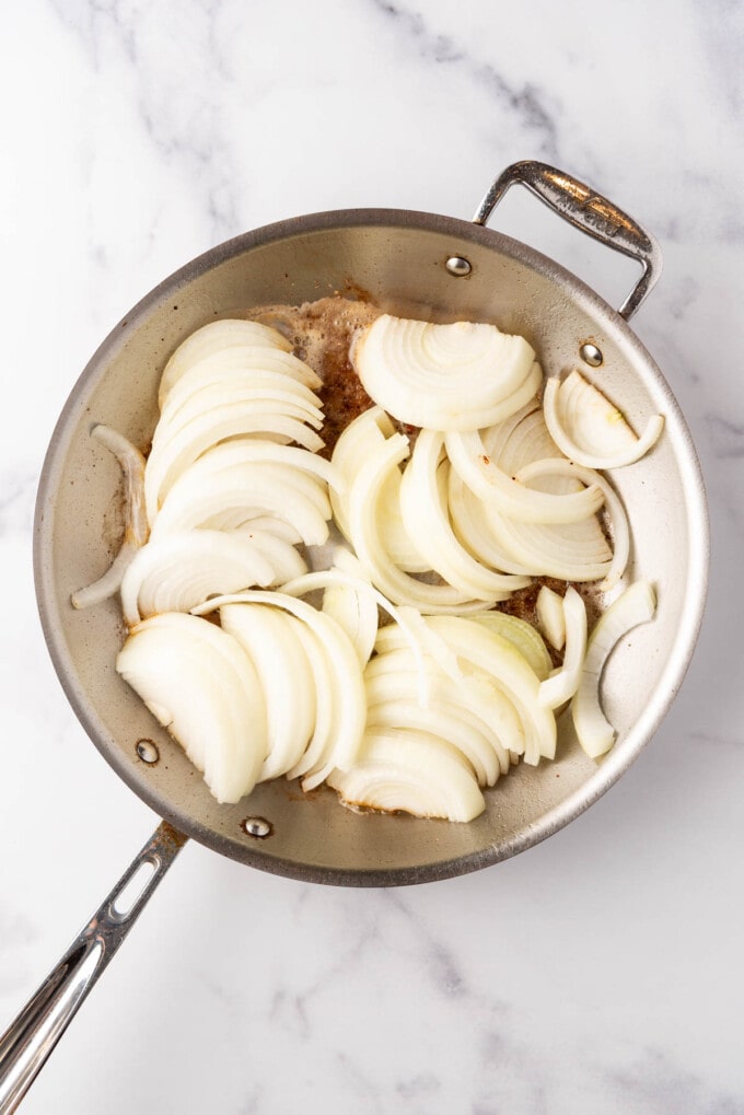 Sliced onions in a pan.