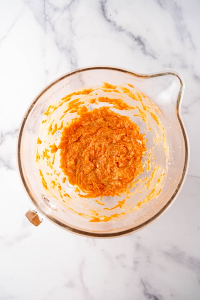 Carrot cookie dough in a large mixing bowl.