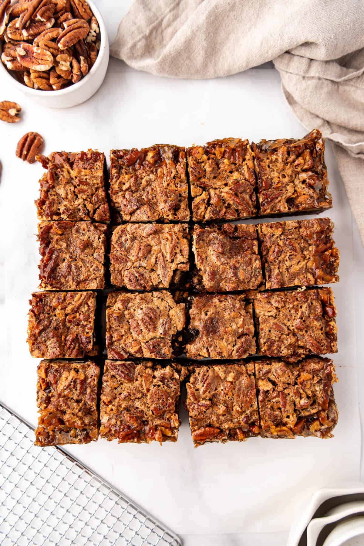 Pecan pie brownies that have been cut into sixteen squares.