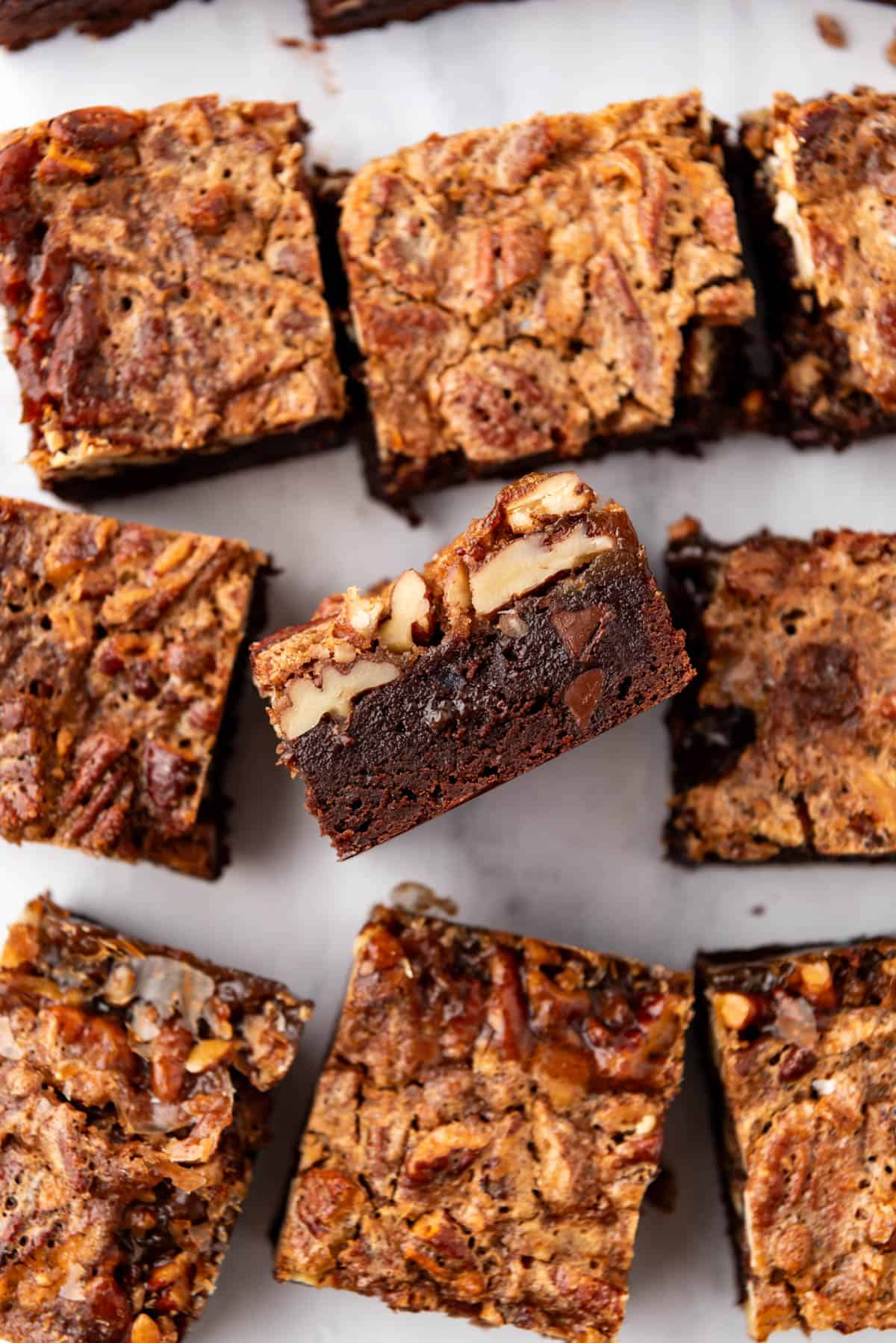 An overhead image of pecan pie brownies cut into squares.