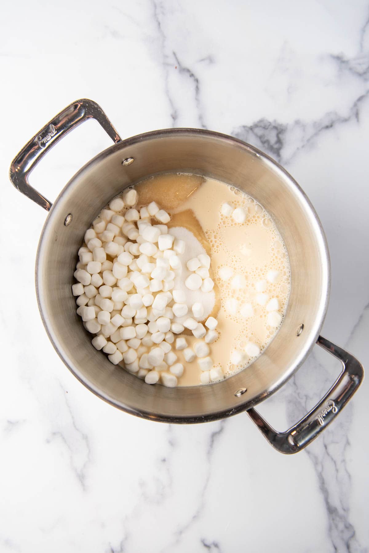Sugar, evaporated milk, and marshmallows in a large pot.