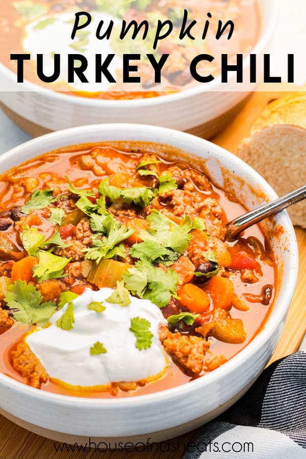A bowl of pumpkin turkey chili with a spoon in it with text overlay.