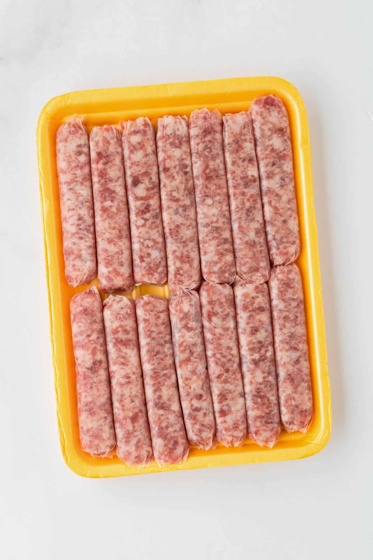 Raw breakfast sausage links in their package.