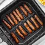 An image of air fryer sausage links in the air fryer basket.