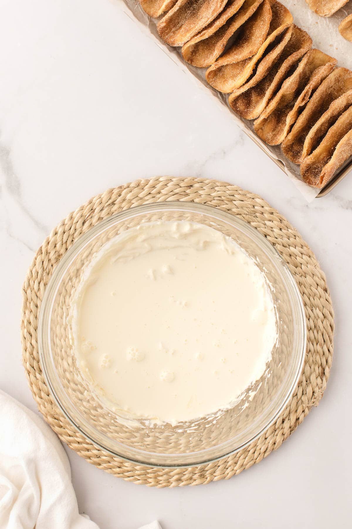 Adding heavy cream to creamy cheesecake filling for dessert tacos.