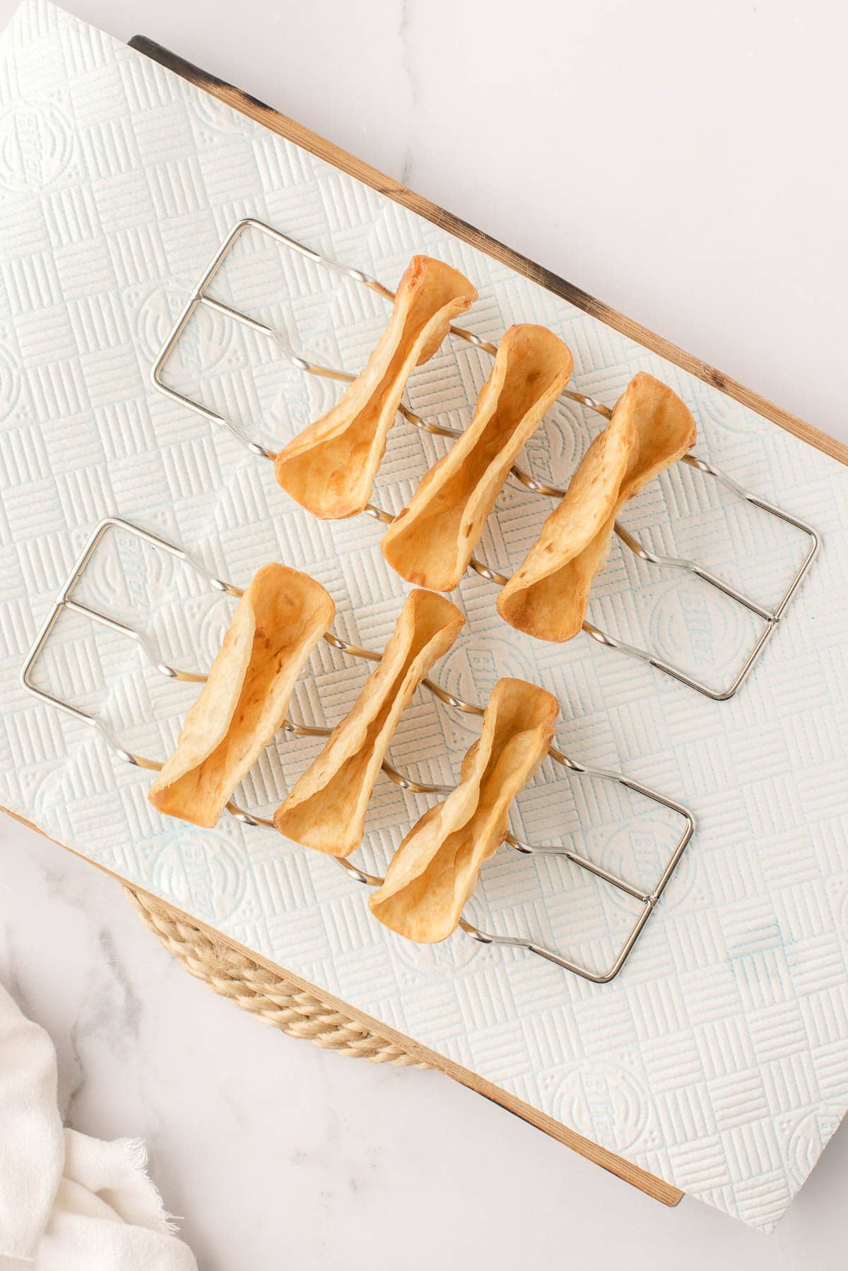 Fried flour tortilla shells in taco holders.