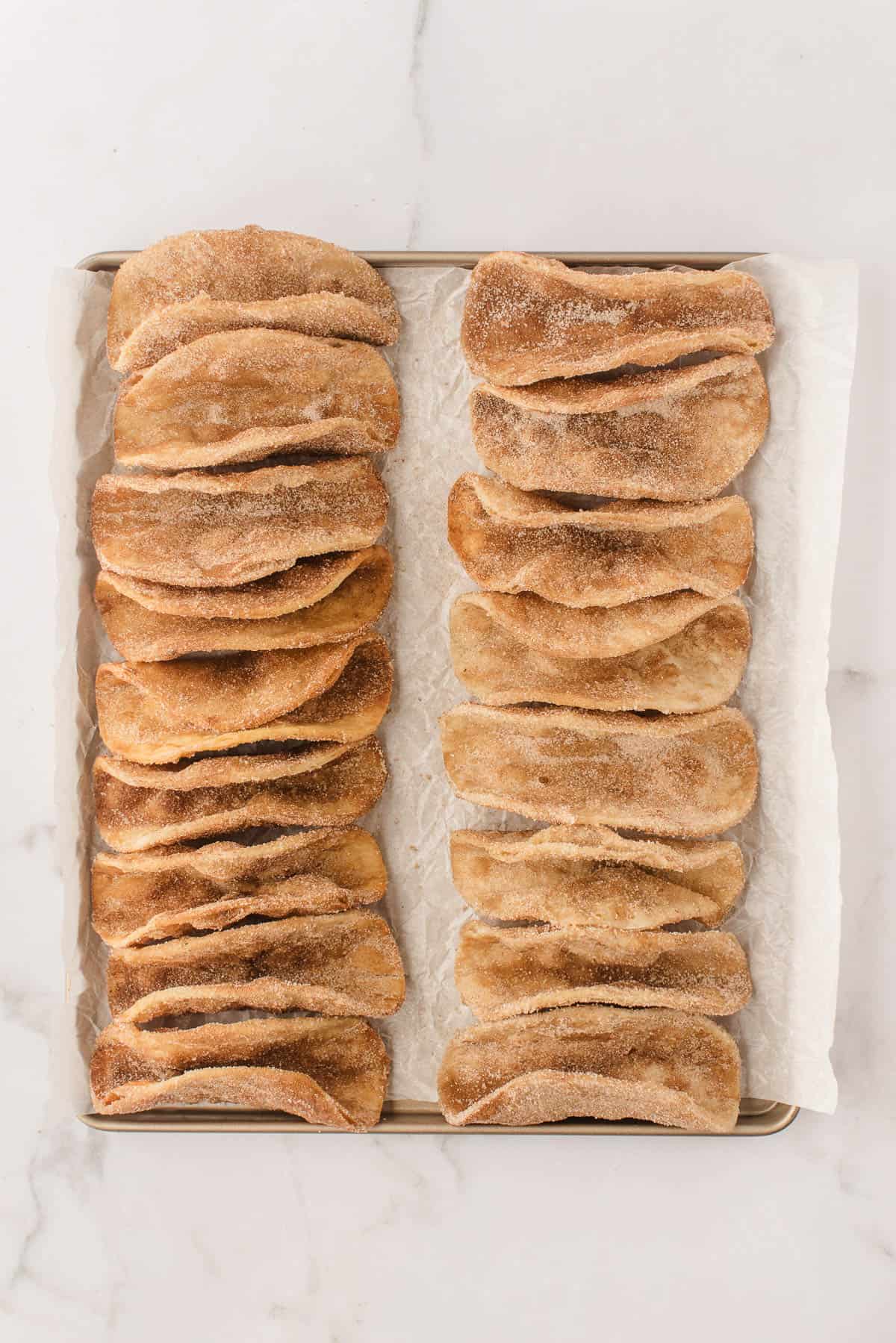 An image of fried tortilla shells coated in cinnamon sugar.
