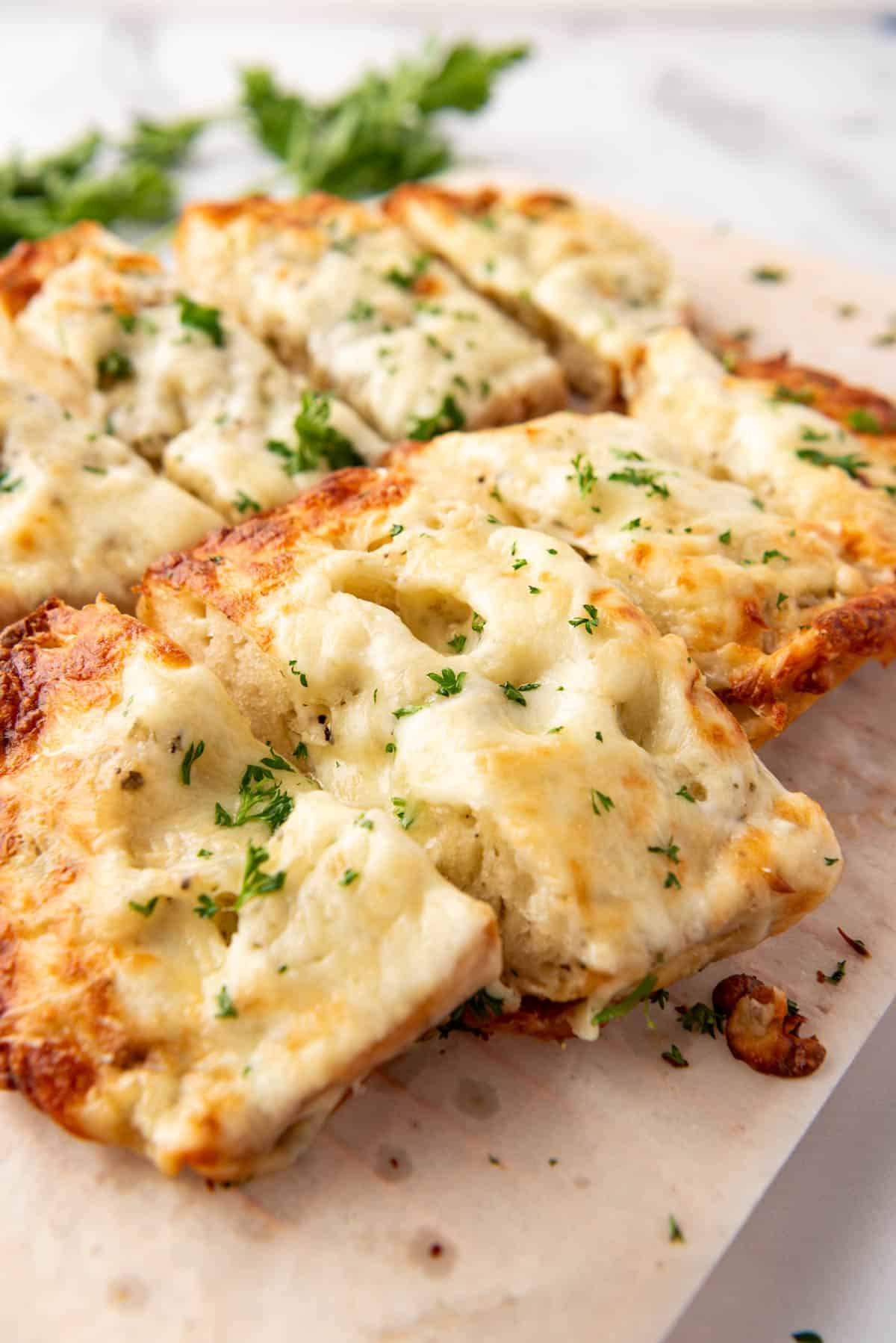 Thick slices of cheesy garlic mozzarella bread.