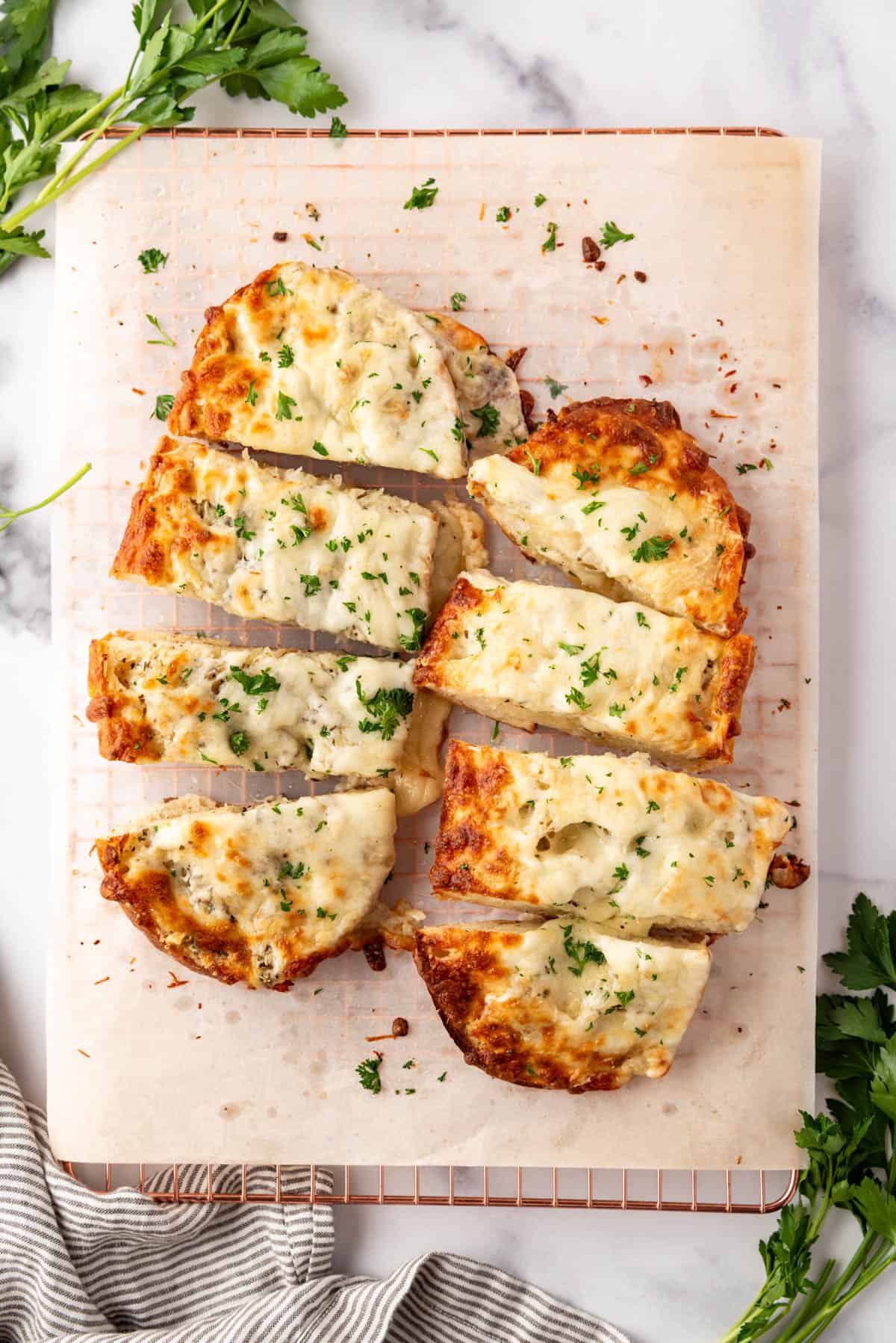Two loves of garlic bread with mozzarella cheese.