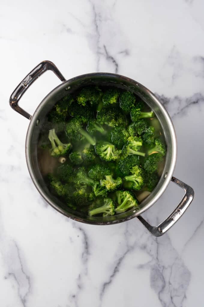 Drained broccoli and pasta in a large pot.