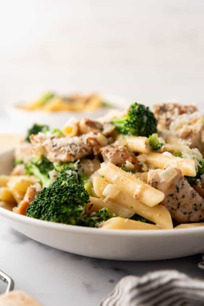 A side view of a bowl of chicken broccoli pasta.