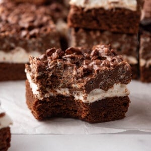 An image of a chocolate peanut butter crunch brownie with marshmallows with a bite taken out of one corner.