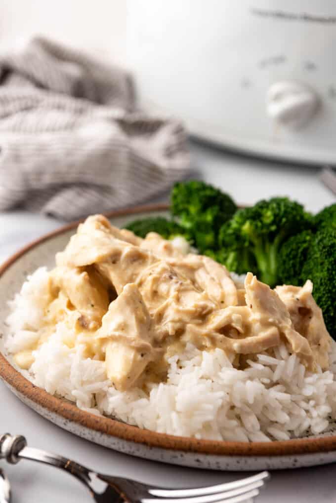 Creamy slow cooker Italian chicken on a bed of white rice with steamed broccoli.