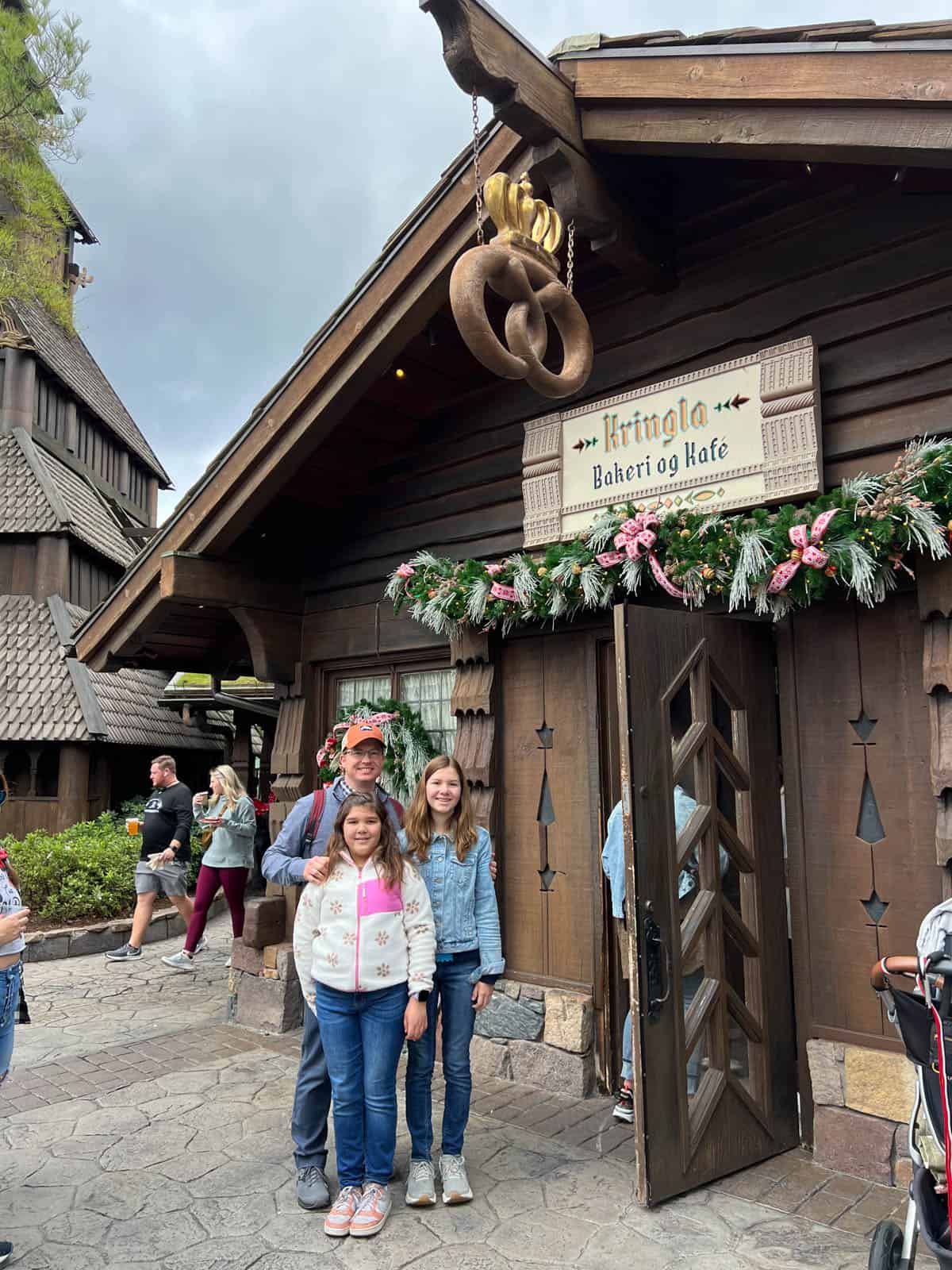 A family in front of the bakery in the Norway region at Epcot.