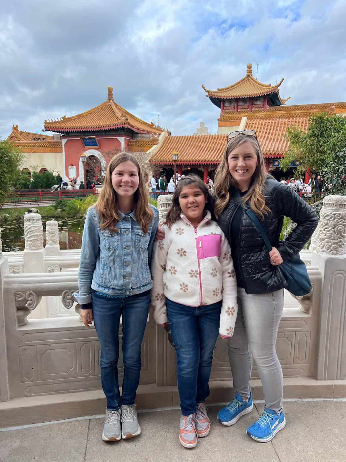 A mom and two kids in the China region at Epcot.