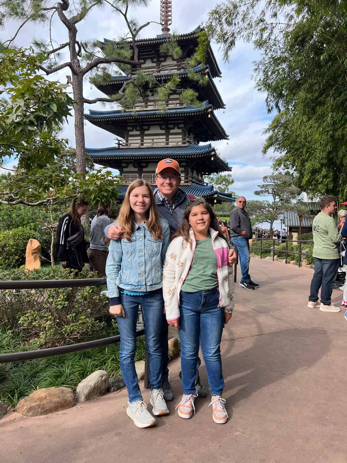 A dad and two kids in the Japan region at Epcot.
