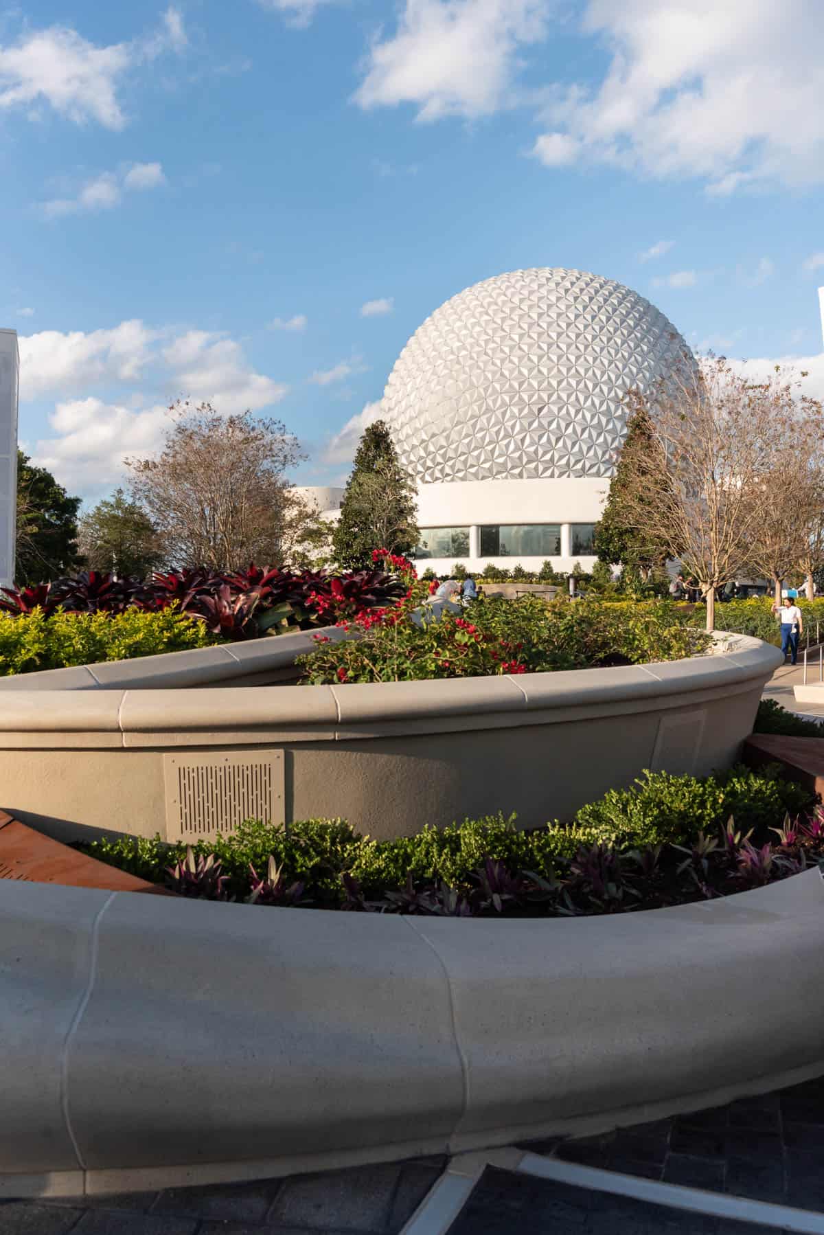 An image of the Epcot sphere with planter beds in front.