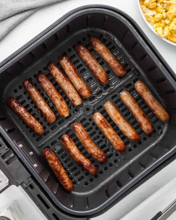 An image of air fryer sausage links in the air fryer basket.