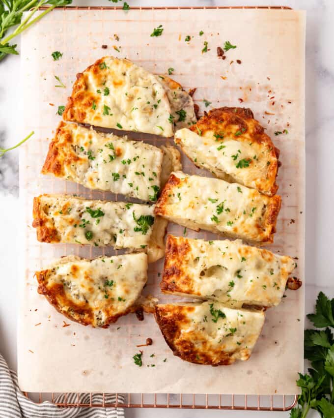 Two loves of garlic bread with mozzarella cheese.