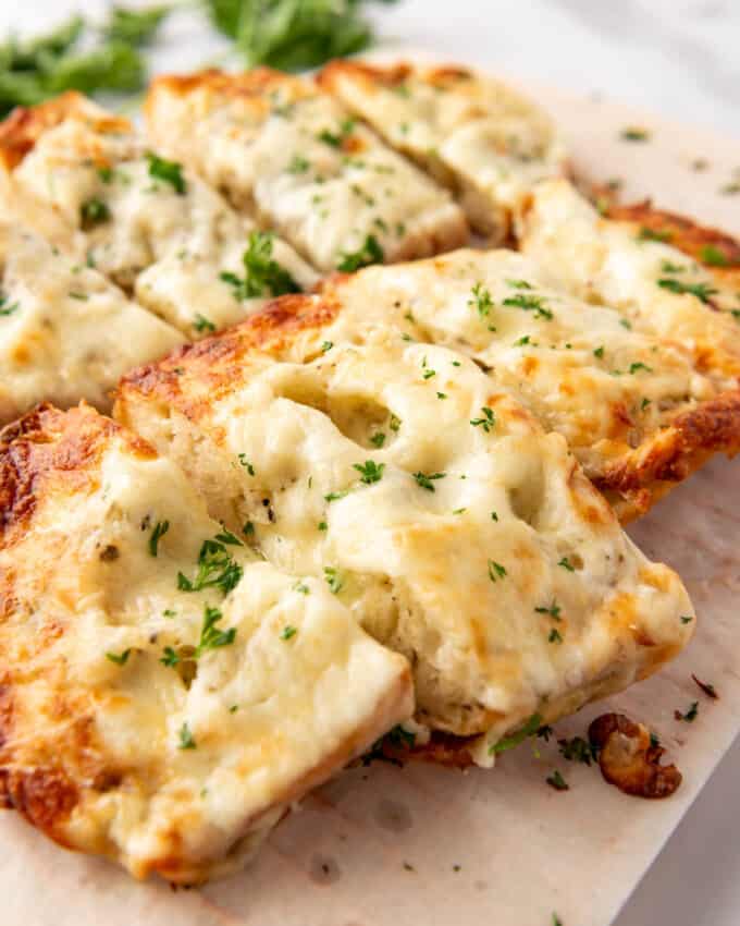 Thick slices of cheesy garlic mozzarella bread.