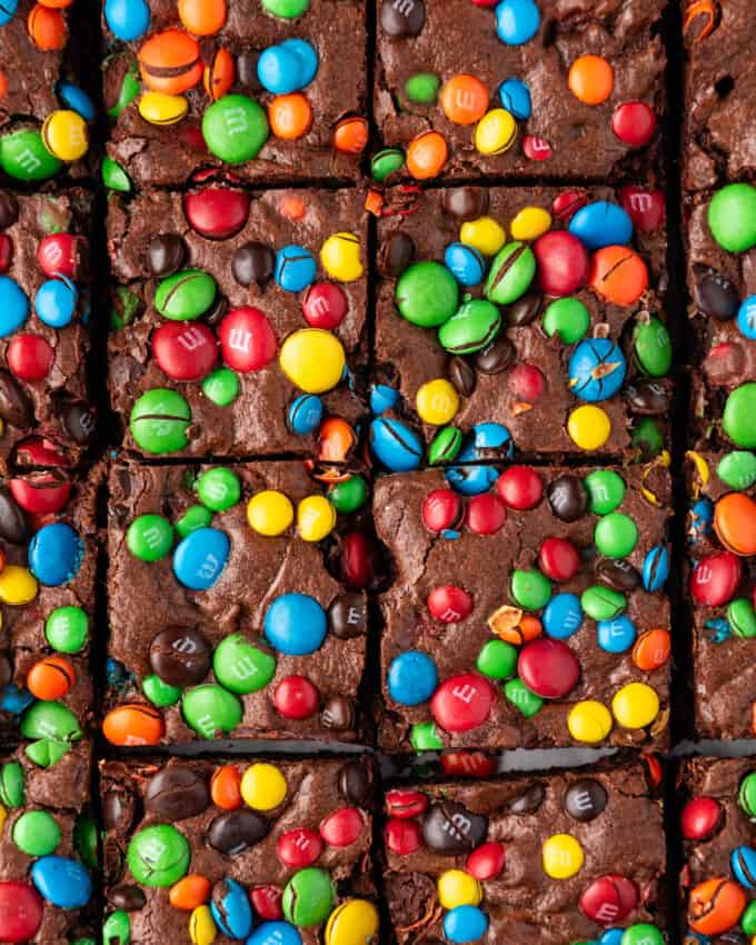 A close up image of M&M brownies cut into squares.