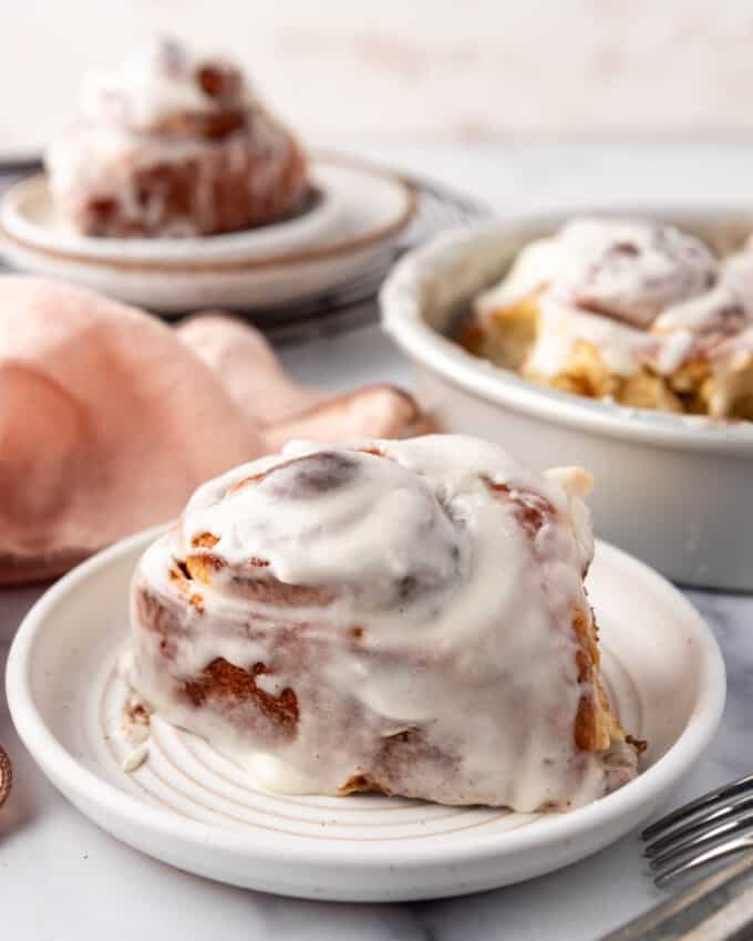 A soft and gooey cinnamon roll on a plate.