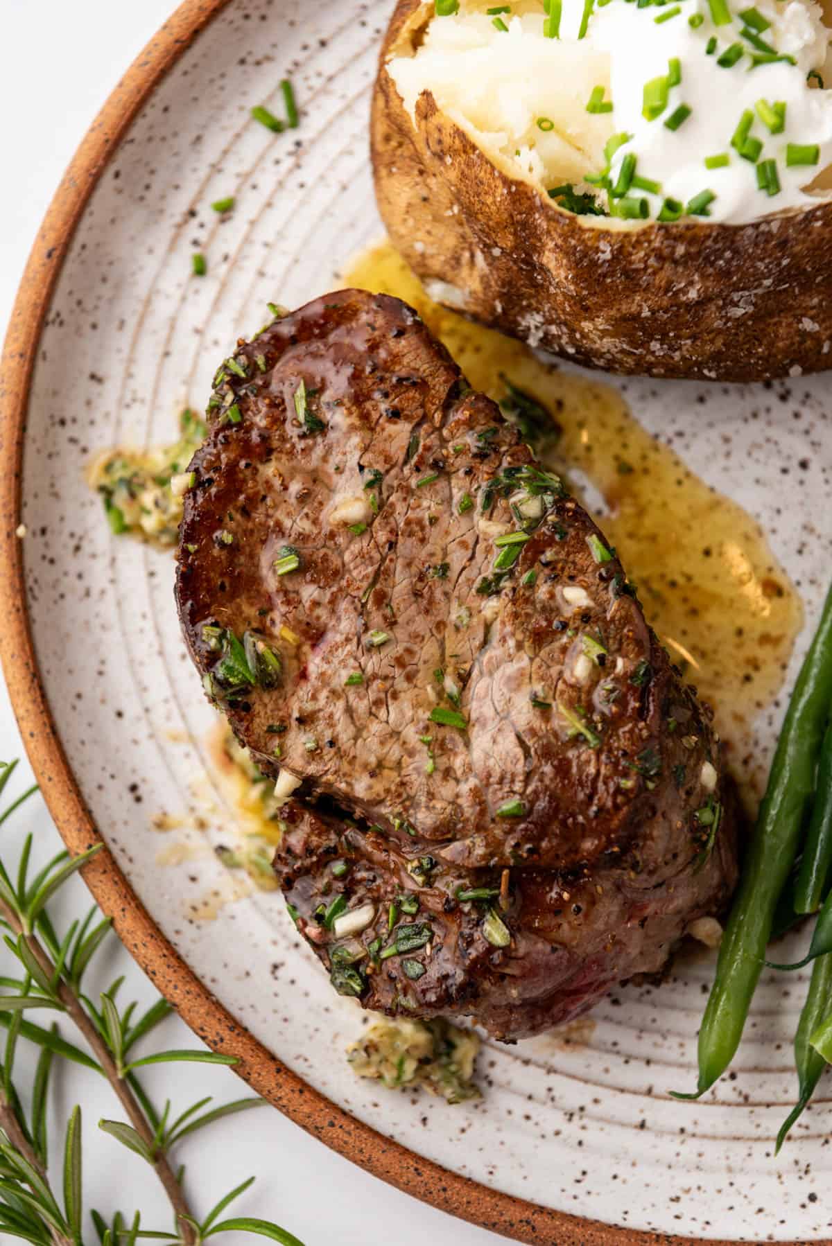 An overhead image of juicy filet mignon on a plate.
