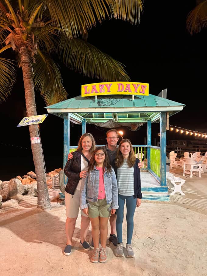 A family in front of an outdoor structure with a Lazy Days sign in Islamorada, Florida.