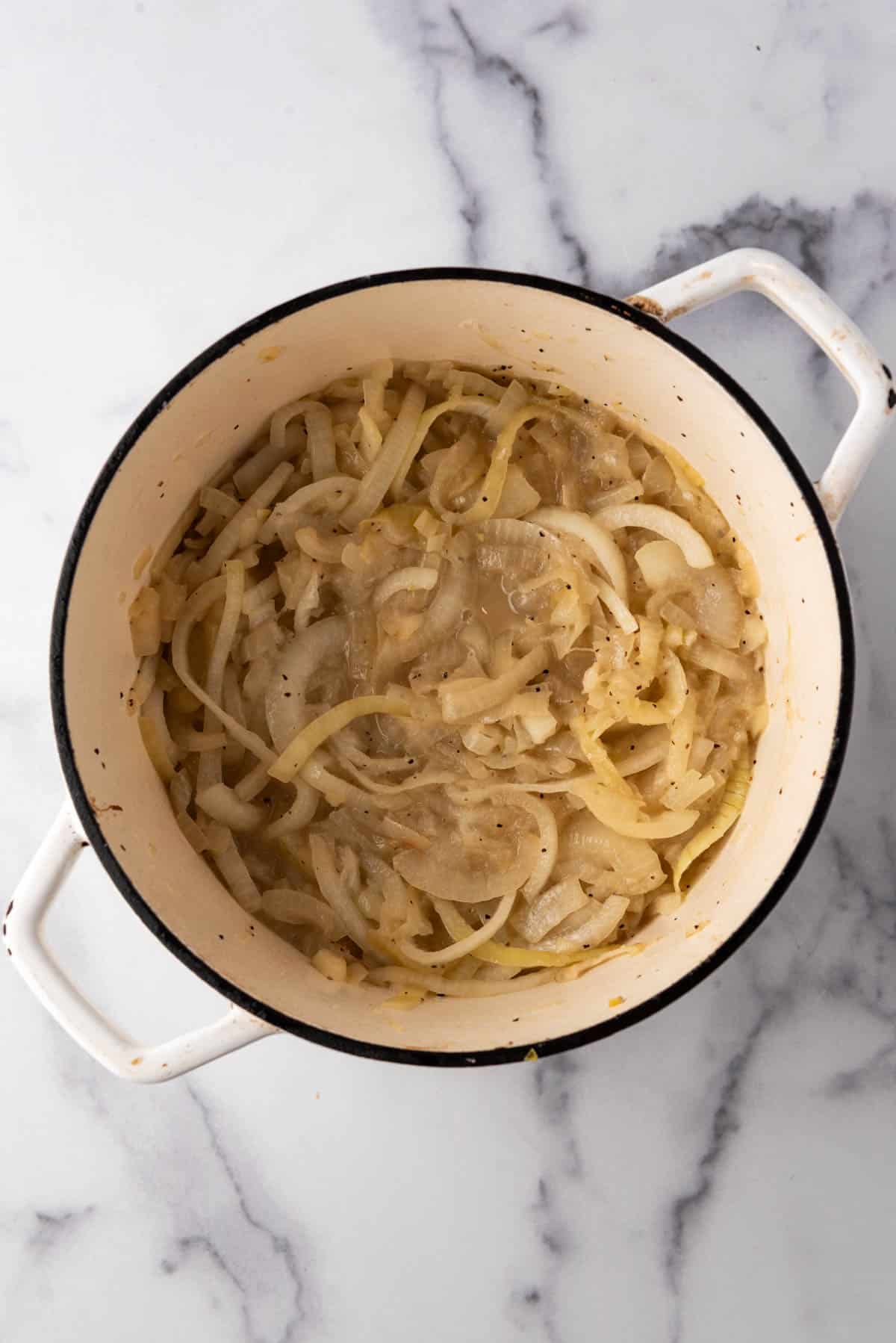 Softened slices onions in a large pot.