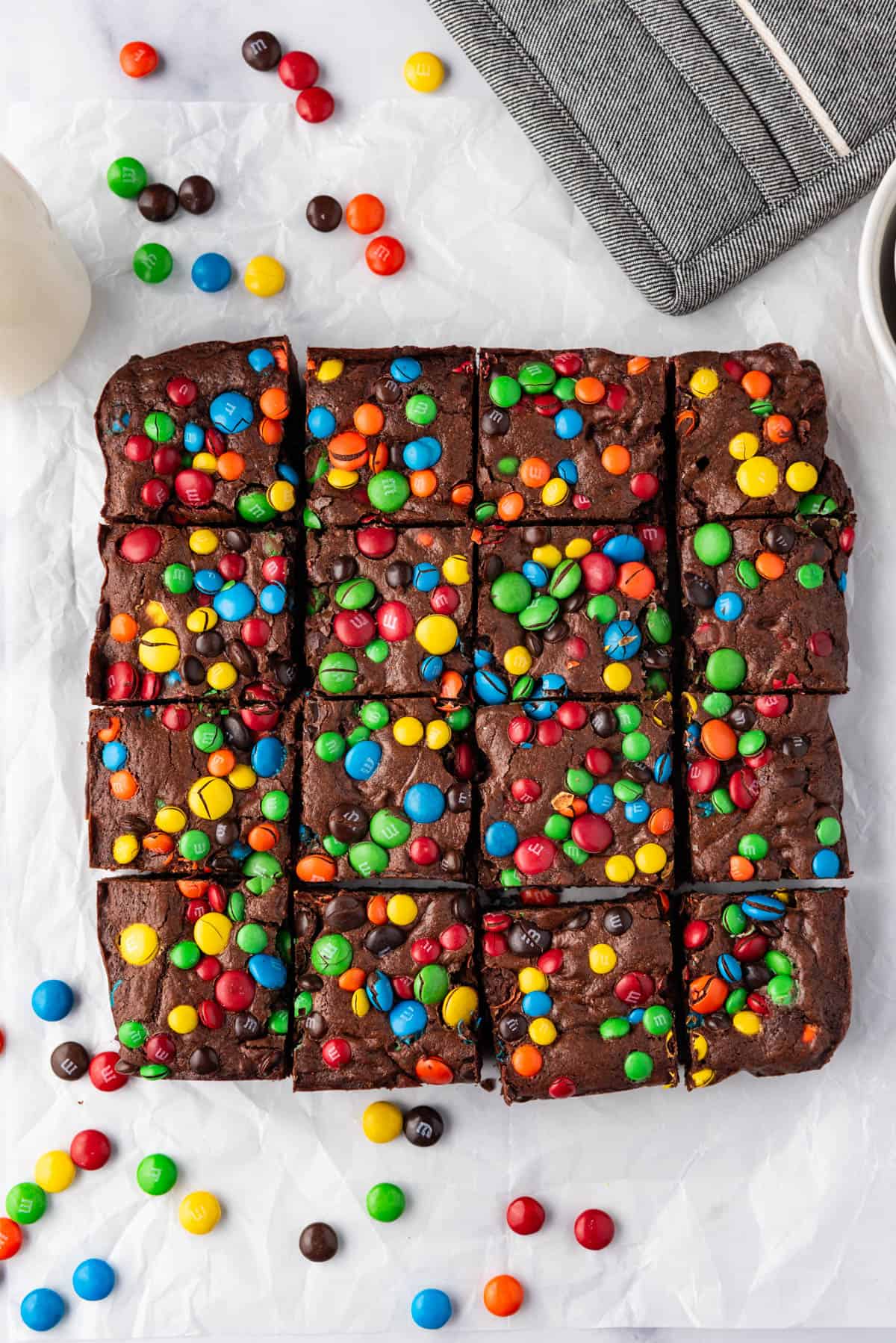 An overhead image of baked M&M brownies cut into squares.